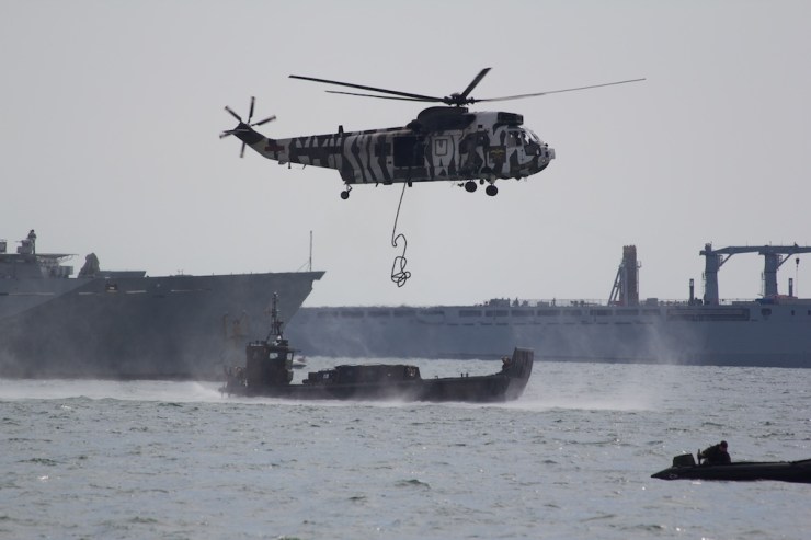 Instead of mounting a beach assault, the helicopter drops a rope...