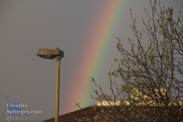 rainbow with a lamppost in the foreground
