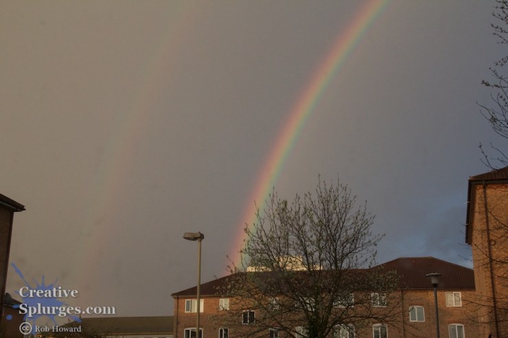 a double rainbow above a housing estate