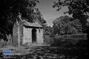 shot of a small building near a small lake.