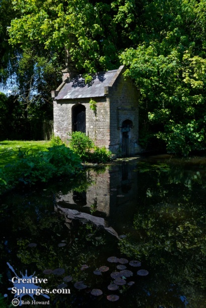 small building reflected in a pond