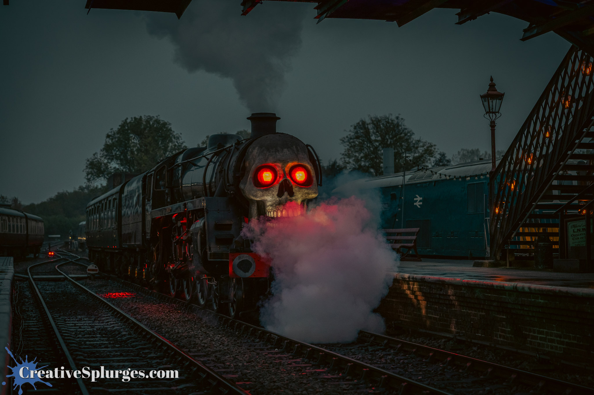 A steam locomotive with a skull-shaped front and glowing red eyes emits steam and smoke at a dimly lit train station.