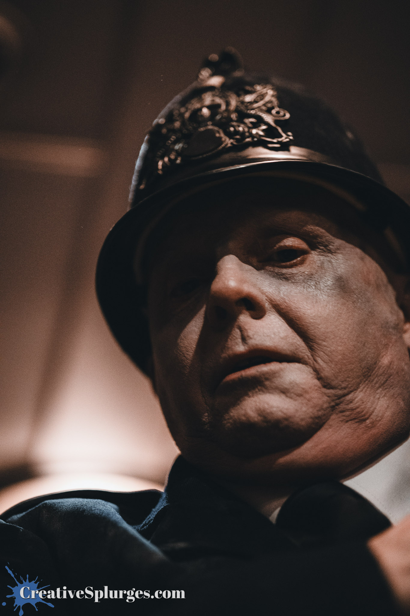 Close-up of a mannequin representing a Victorian-era police officer, wearing a traditional helmet and dark uniform, with a somber expression.