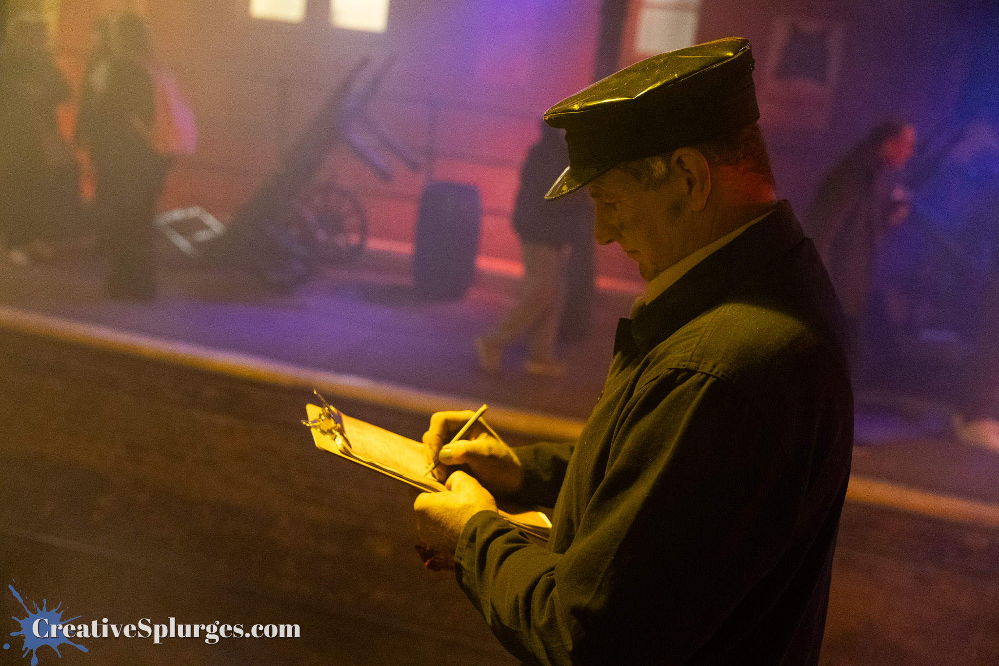 A man in a vintage uniform with a hat is holding a clipboard and writing notes, surrounded by a smoky, dimly lit environment.